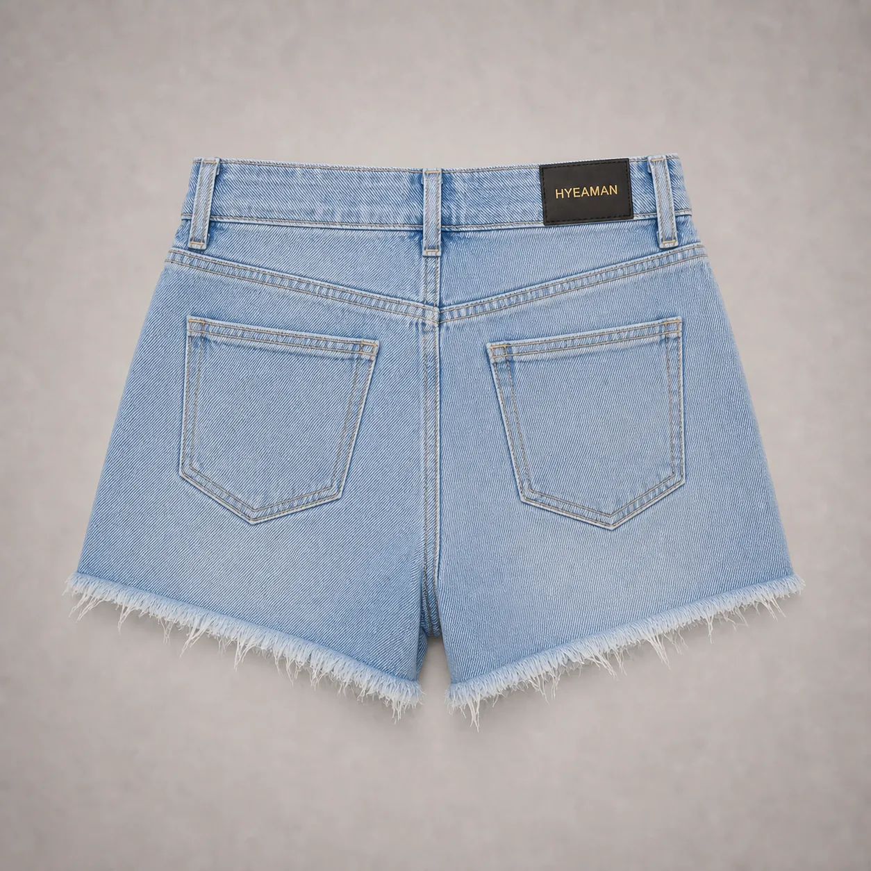 Ladies light blue frayed denim shorts back view